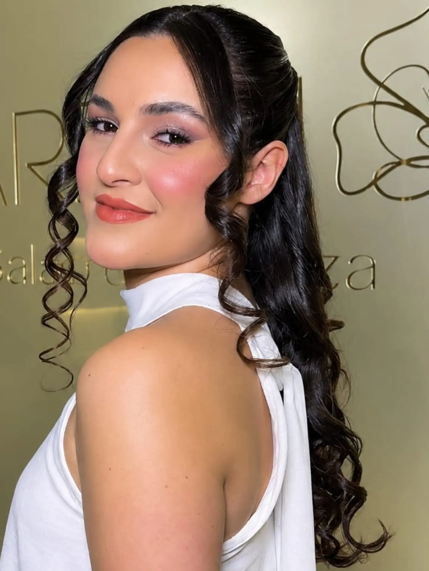 Produção de maquiagem com cabelo preso e ondas